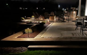 Cozy outdoor patio with warm lighting at night.