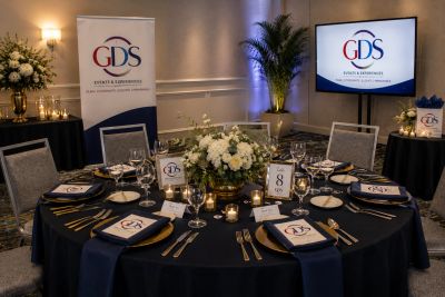 Elegant round table set for a formal event with GDS branding.
