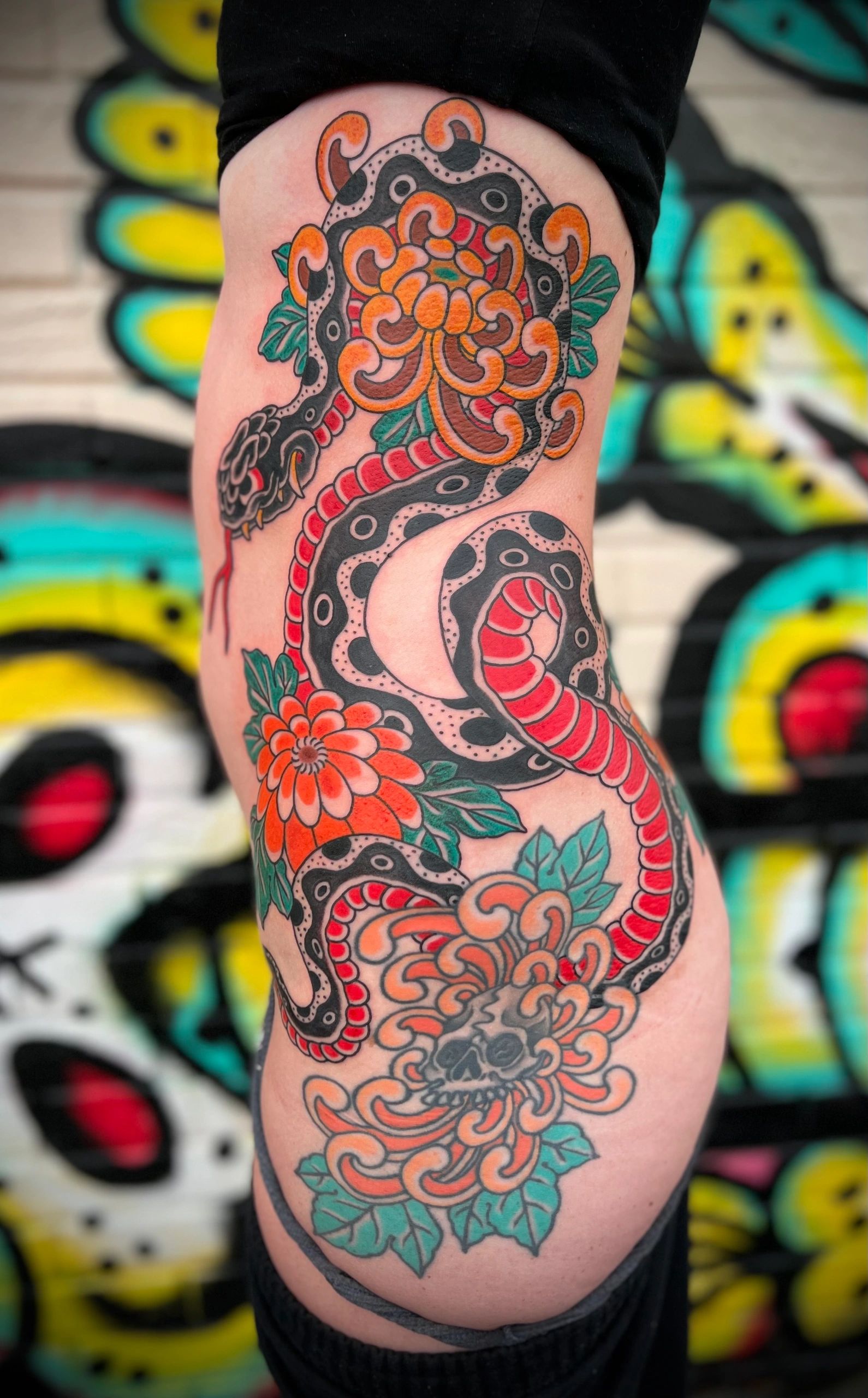 Snake and chrysanthemum mum Japanese rib piece tattoo