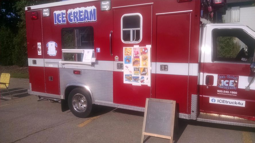 Ice cream truck service window.  Parked at a food truck event.