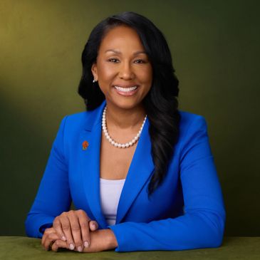 Professional woman in blue blazer smiling confidently.