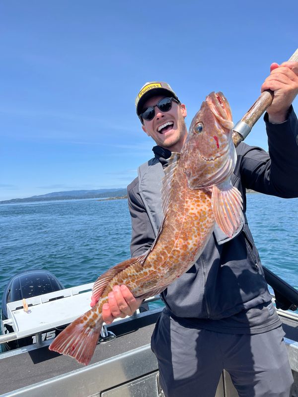 Guest proudly displaying a bottom fish catch on a halibut fishing Sooke expedition