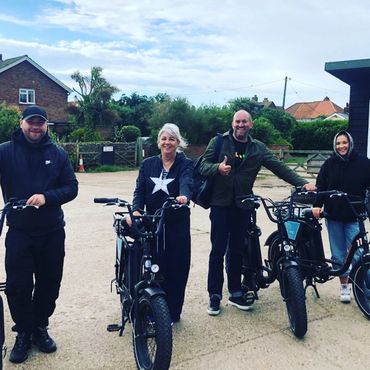 a happy family out on e-bikes