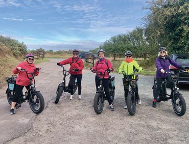 group of female friends on e-bikes