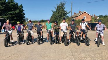 group of ten male friends on e-bikes