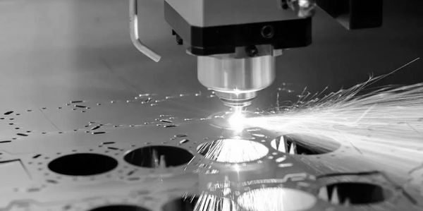 A laser cutting machine sparks as it cuts metal with precision.