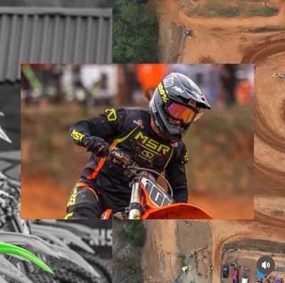 Motocross rider in action on a dirt track wearing full gear.