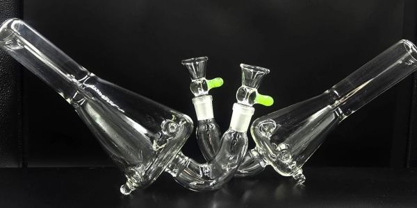 Two clear glass bongs placed opposite each other.