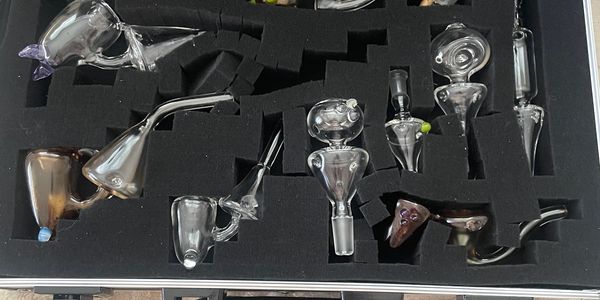 Set of glass smoking pipes in a foam case.