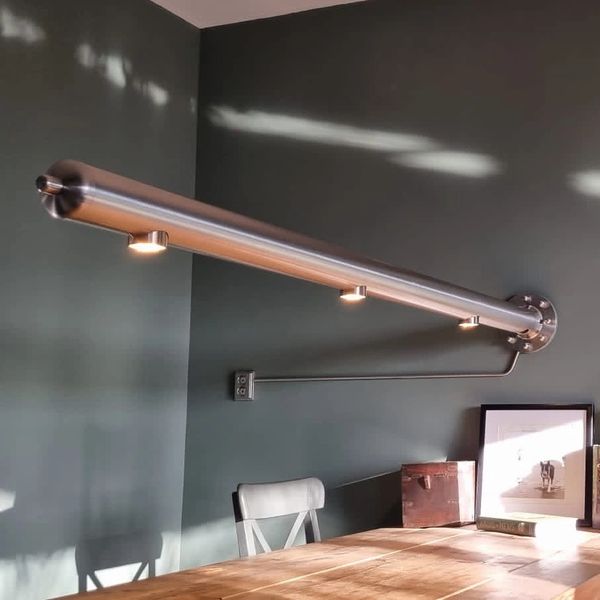 Stainless steel Design lamp over dinner table. 