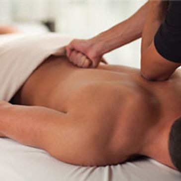 Person receiving a deep tissue massage on their back.