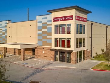 Modern Storage Sense self-storage facility with multiple floors and parking spots.