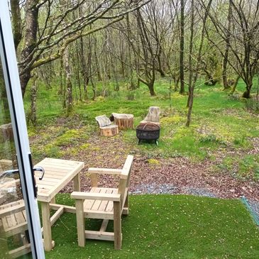 Two seating areas and firepit at the woodland cabin.