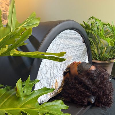 Woman relaxing in a sauna with an eye mask.