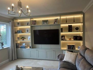 Custom TV wall unit with a modern electric fire, installed by a professional Isle of Man joiner