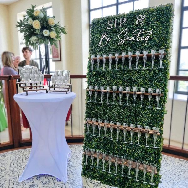 Elegant champagne glass seating display with floral decoration at an event.