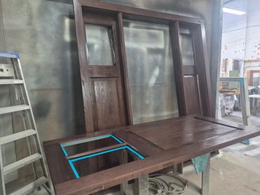 Wooden door frame under construction in workshop.