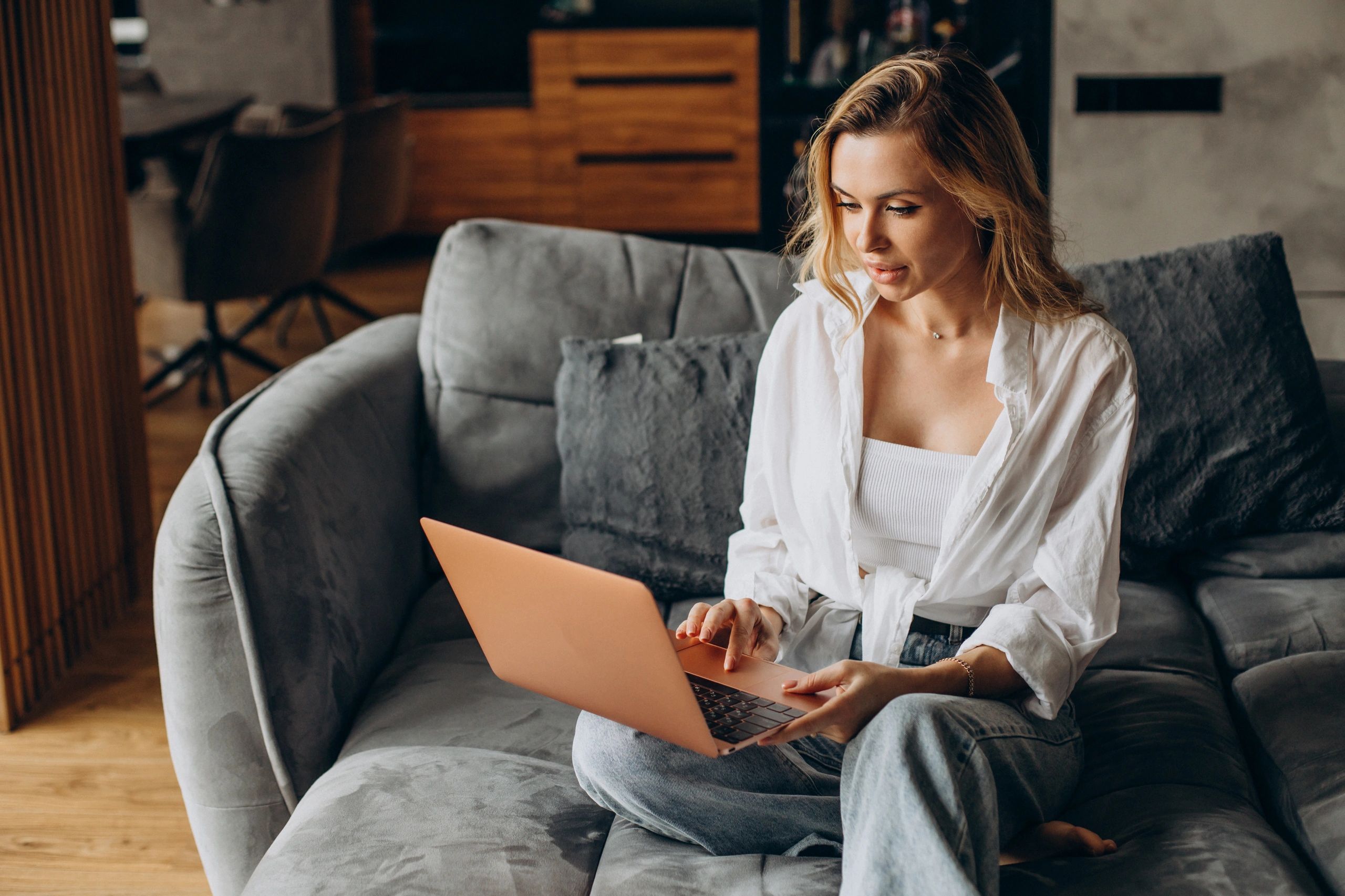 Woman using laptop at home for remote work opportunity
