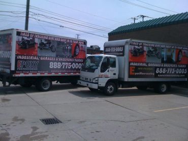 Two trucks advertising industrial garage floor epoxy services.