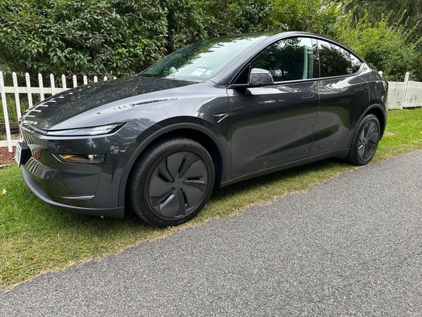 Side view of gray electric luxury sedan.