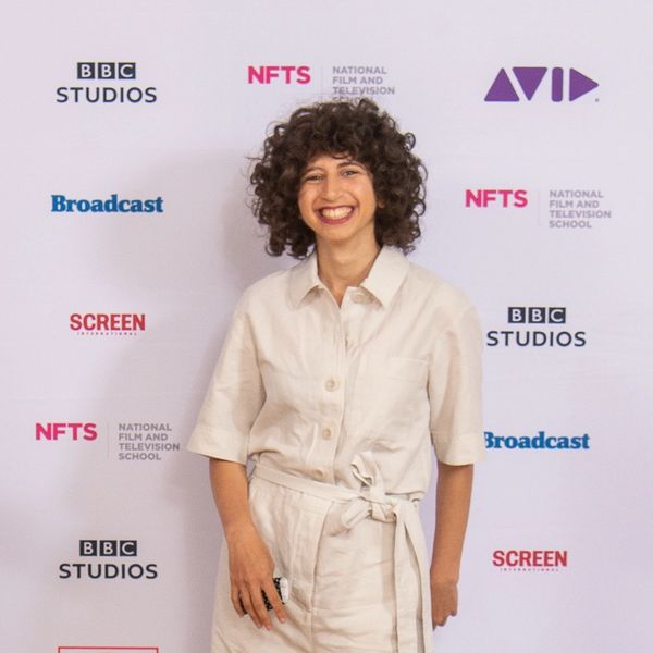 Person smiling in front of a media backdrop with BBC and NFTS logos.