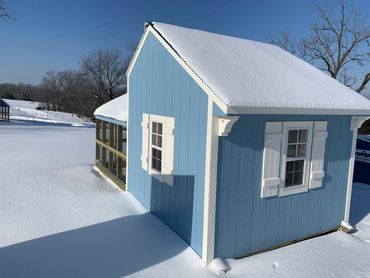The back of a Cottage Coop (with snow on the roof)