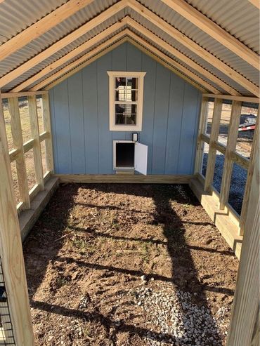 The large run area of this Cottage Coop ends with an optional automatic door.