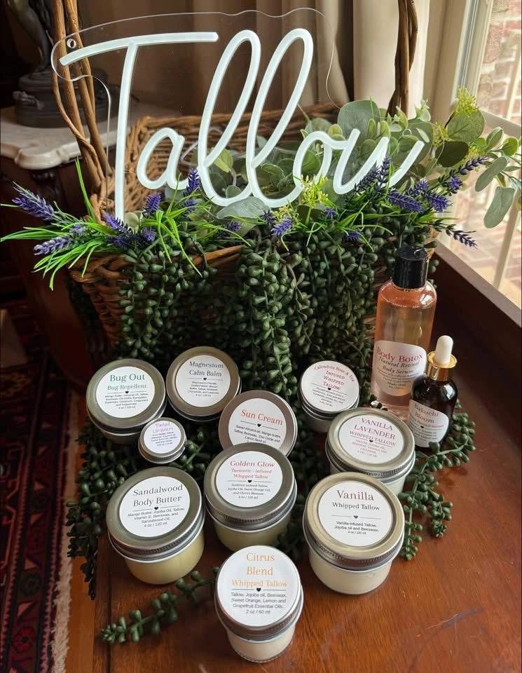 Handmade natural skincare products displayed with greenery and a wicker basket.