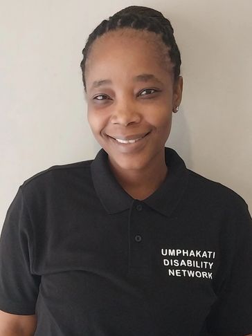 Smiling woman in a black polo shirt.