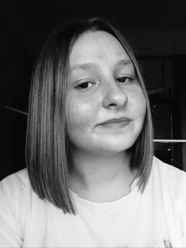 Black and white portrait of a young woman with straight hair and a slight smile.