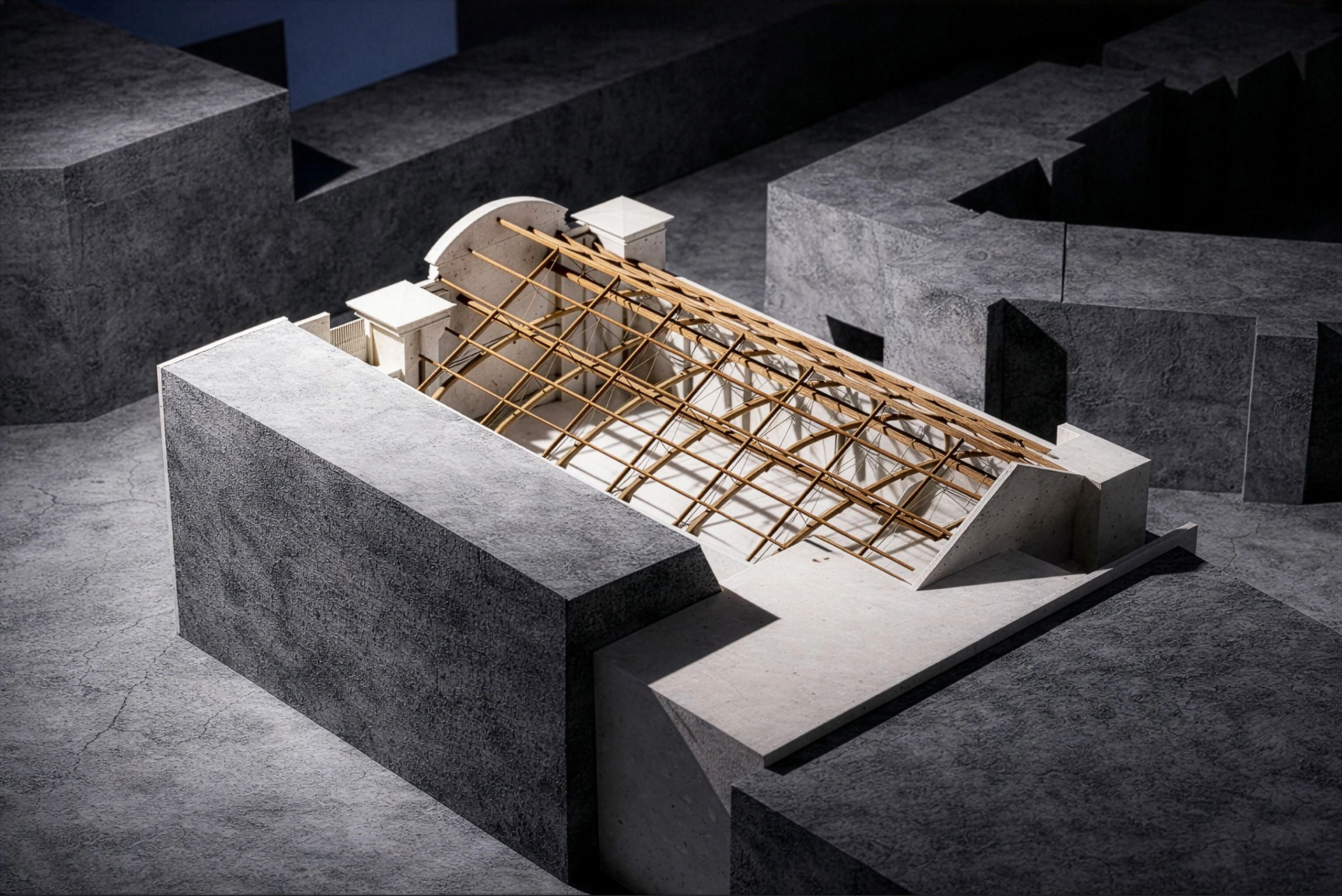 Architectural model showing a partially constructed roof structure with wooden beams.