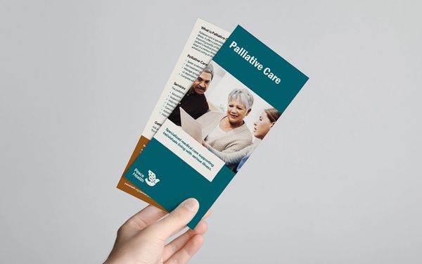 Hand holding a pamphlet about palliative care from Peace Health.