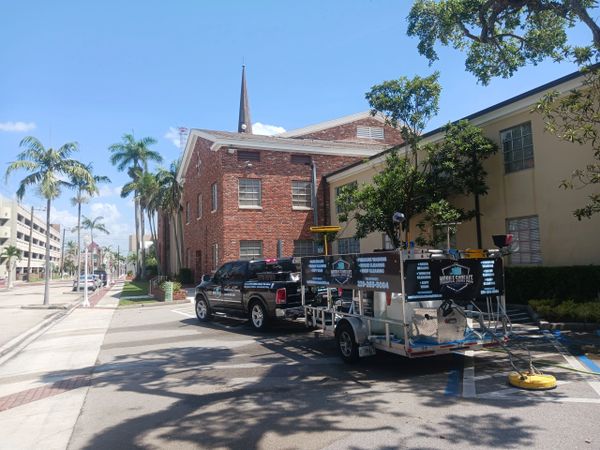 Church building pressure washed with business truck and equipment