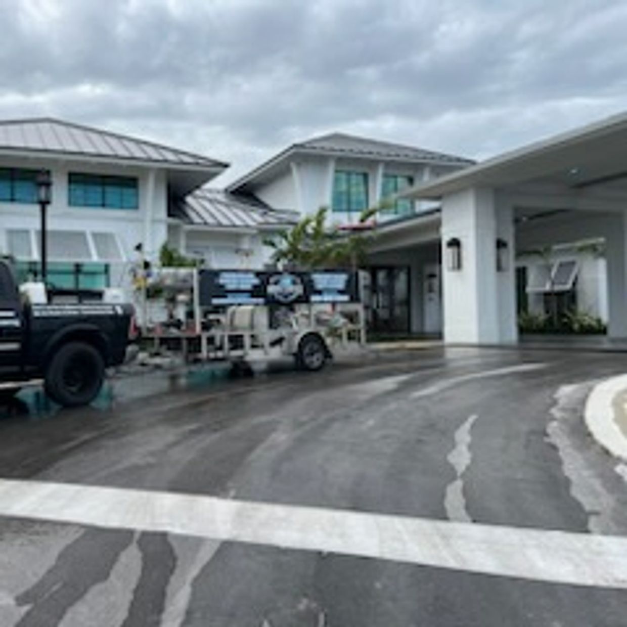 commercial building cleaned with a pressure washing trailer in front 