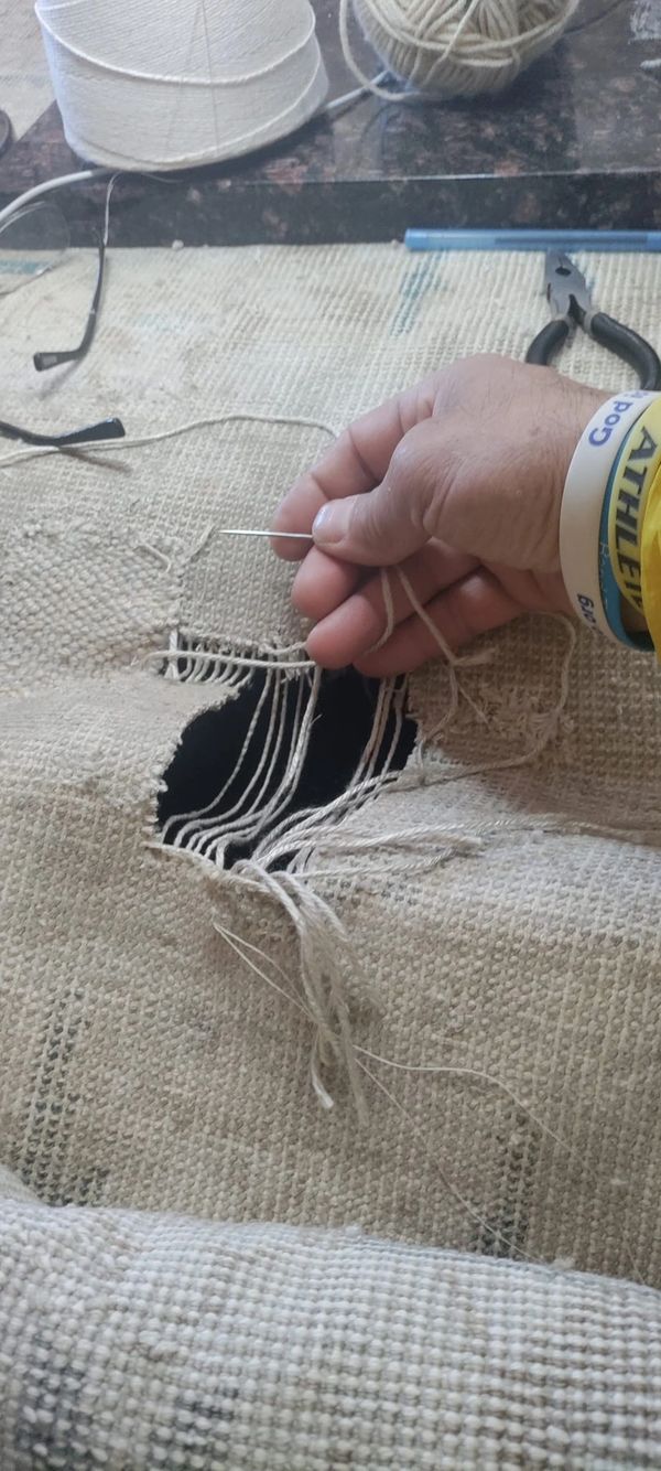 hand repairing damaged rug