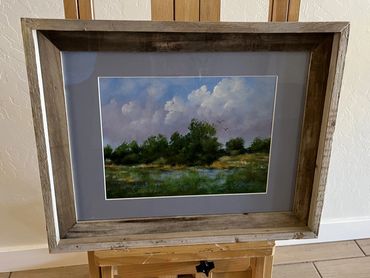 Green grass and trees  with a cloudy sky 
