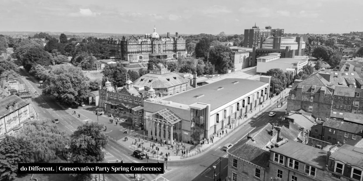 Aerial view of a city intersection with historic and modern buildings in black and white.