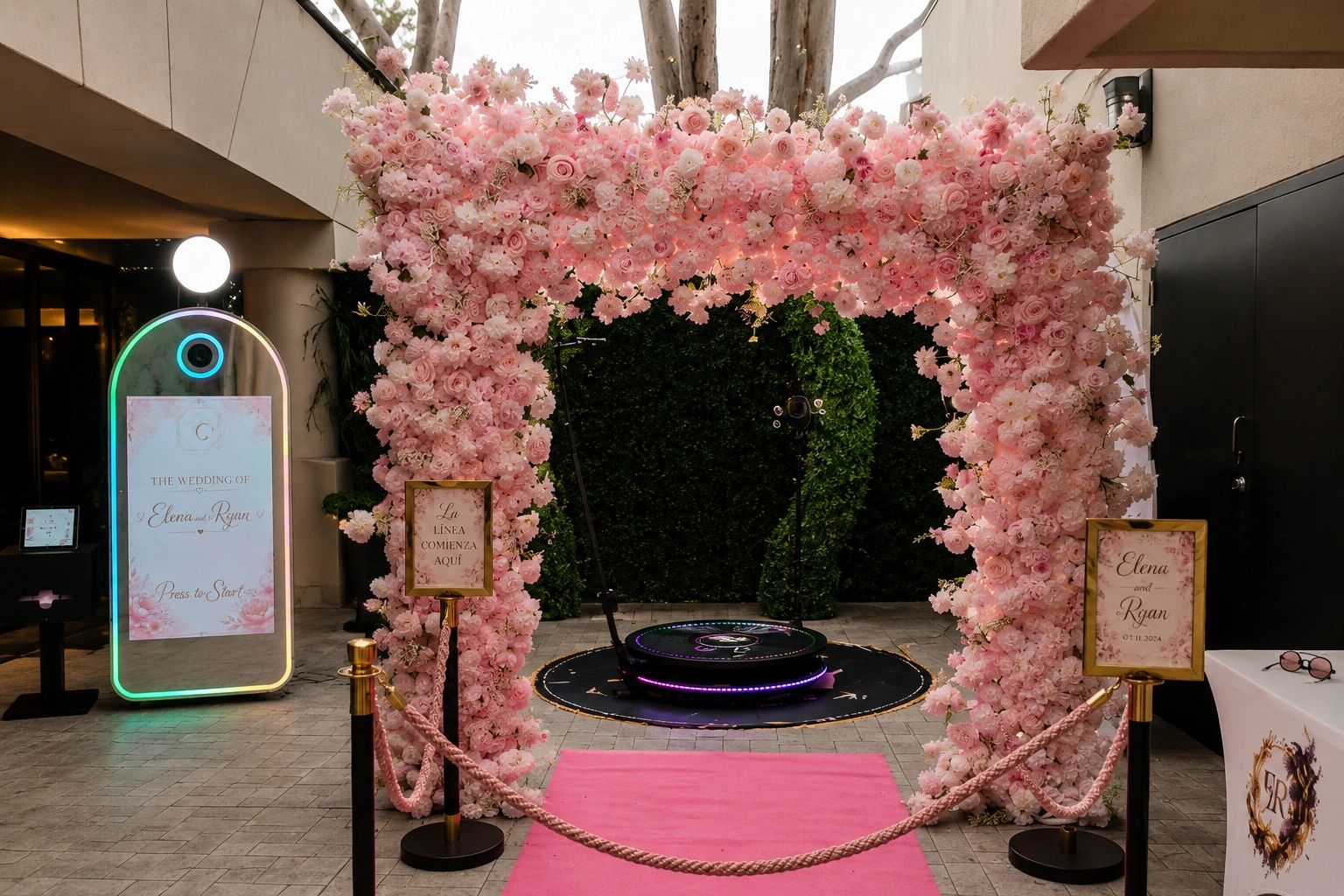 Elegant pink floral archway as an entry to the 360 video booth and a Digital Mirror photo booth at a wedding.
