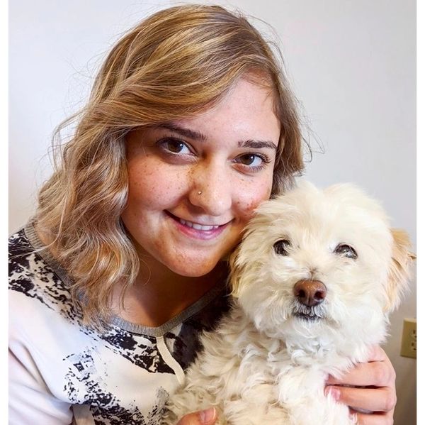 Melanie veterinary receptionist with a dog