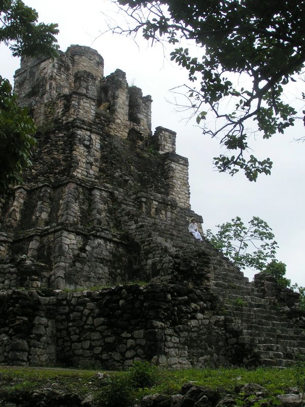 A tall pyramid with numerous stone columns and steep steps.