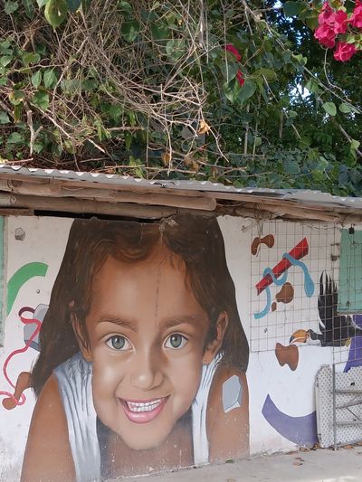 Mural of a young girl, one of countless murals throughout Bacalar.