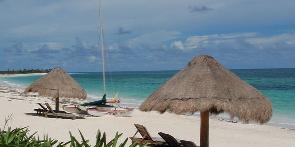 View of beach, ocean, and catamaran.