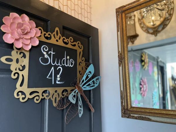 Door to "Studio 42" with decorative flower and dragonfly.