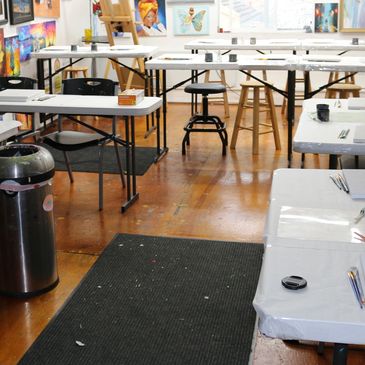 Art classroom with tables and chairs.