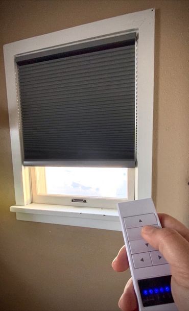Window with remote controlled shades 
