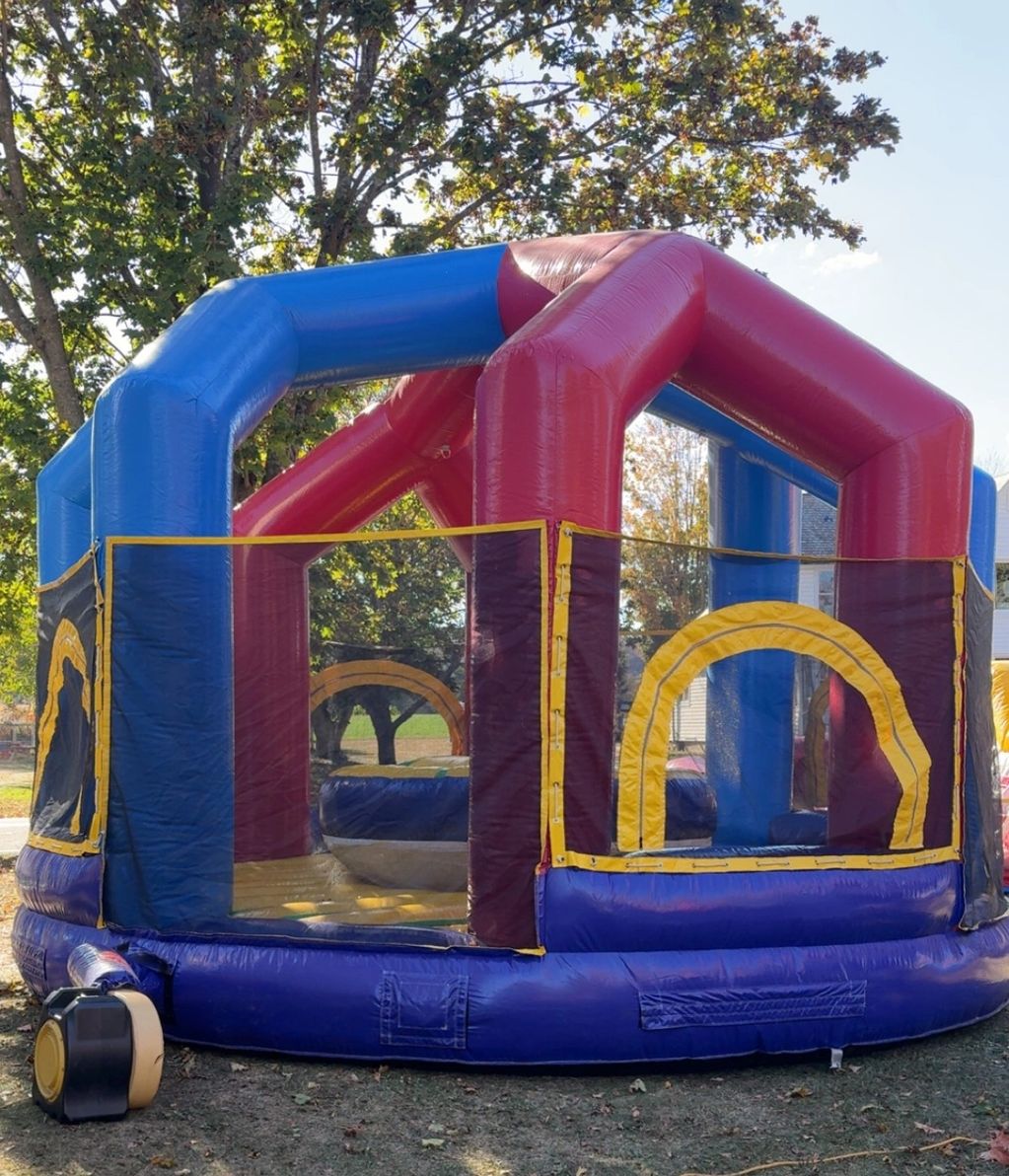 Colorful inflatable bounce house set up outdoors on a sunny day.