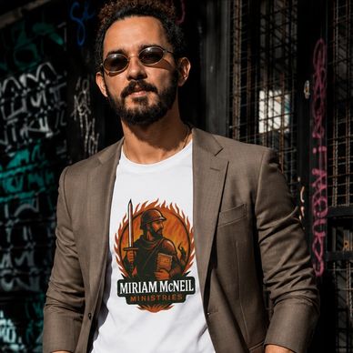Man wearing sunglasses, brown blazer, and graphic tee.