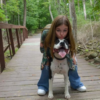 Karlee hugging her pet dog at a park