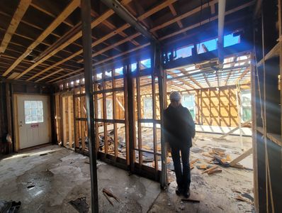 Staff member, Heidi in what will be the area for our new Classroom, Common area, and Stroller storag