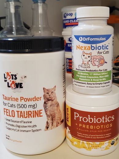 Three containers of cat supplements and probiotics.